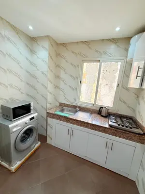 a kitchen with a sink and a washing machine at Appart N35 COSY CONFORT FAMILY in Marrakech