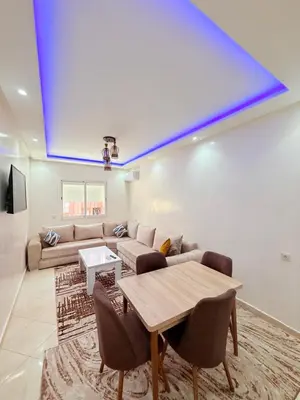 a living room with a couch and a table at Appart N35 COSY CONFORT FAMILY in Marrakech