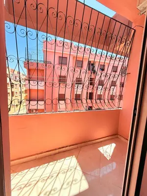 a glass door with a view of a building at Appart N35 COSY CONFORT FAMILY in Marrakech