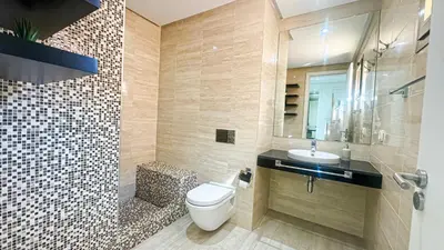a bathroom with a toilet and a sink at Appartement PRESTIGIA MARRAKECH VILLAGE in Marrakech