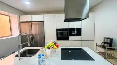 a kitchen with a bowl of fruit on a counter at Appartement PRESTIGIA MARRAKECH VILLAGE in Marrakech