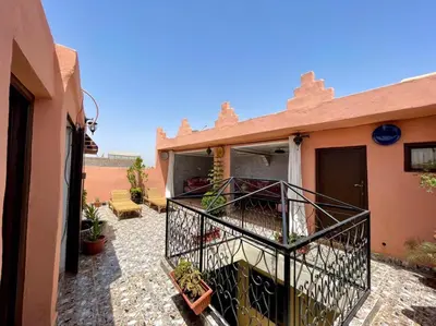 a balcony of a house with plants on it at Terrace Room with Atlas View in Marrakech