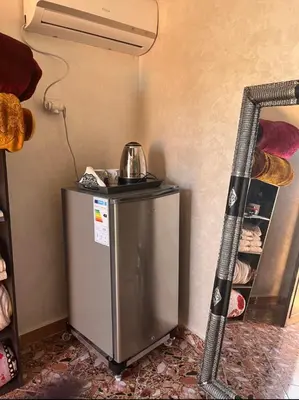 a small refrigerator in the corner of a room at Terrace Room with Atlas View in Marrakech