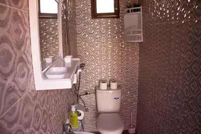 a small bathroom with a toilet and a sink at Terrace Room with Atlas View in Marrakech
