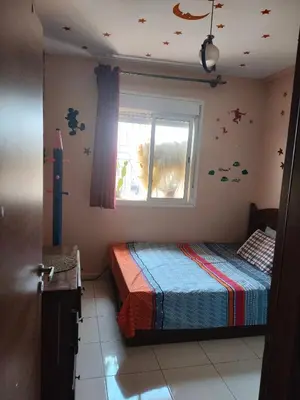 a bedroom with a bed and a window with stars on the wall at Mhamid10, Albahja Route Agafay in Soltane