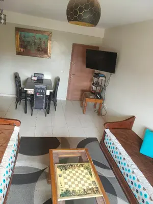 a living room with a chess board on a table at Mhamid10, Albahja Route Agafay in Soltane