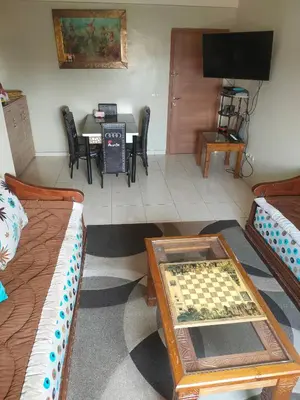 a living room with a chess board on a table at Mhamid10, Albahja Route Agafay in Soltane