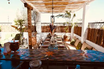 a patio with a table with plates of food on it at Riad de charme Aïtana au cœur de la Médina in Marrakech