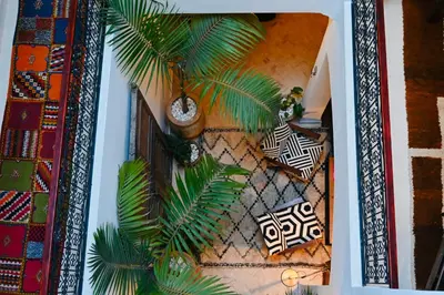 an overhead view of a living room with palm trees at Riad de charme Aïtana au cœur de la Médina in Marrakech