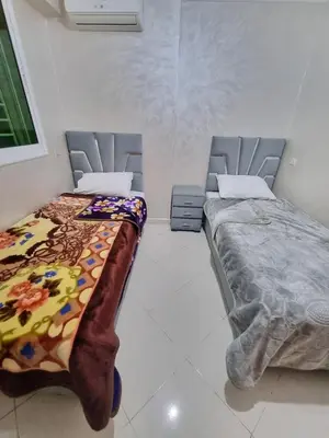 two beds sitting next to each other in a room at Relaxing Stay Close to Everyting in Marrakech