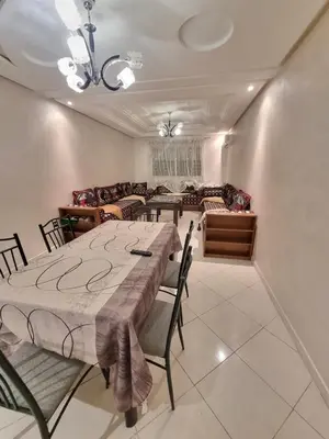 a dining room with a table and chairs and a couch at Relaxing Stay Close to Everyting in Marrakech