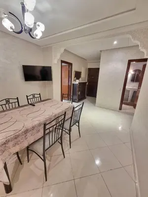 a dining room with a large table and chairs at Relaxing Stay Close to Everyting in Marrakech