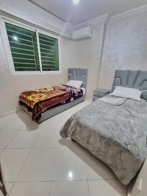 a bedroom with two beds and a window at Relaxing Stay Close to Everyting in Marrakech