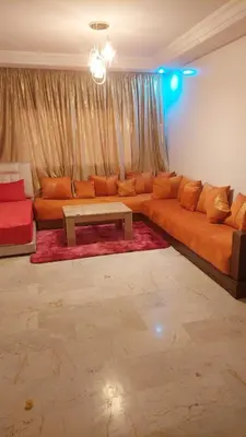 a living room with a couch and a table at Le Central Hivernage 8-37-44 face gare CTM et a 10mn de l'aéroport in Marrakech