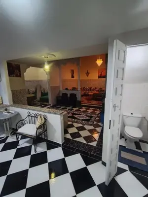 a lobby with a checkered floor and a bathroom at Raid Mariama in Marrakech