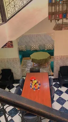 a table and chairs in a room with a table at Raid Mariama in Marrakech