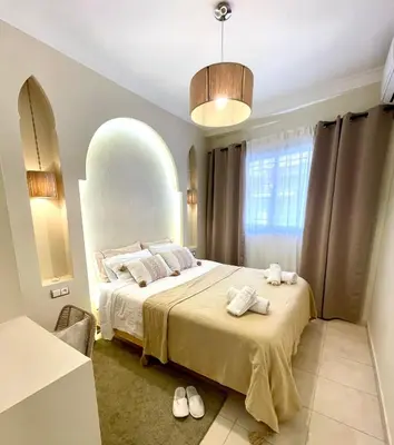 a bedroom with a large bed with towels on it at Dar Mimouna - Authenticité & Confort Moderne in Marrakech