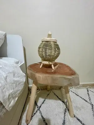 a vase sitting on a table next to a bed at Dar Mimouna - Authenticité & Confort Moderne in Marrakech
