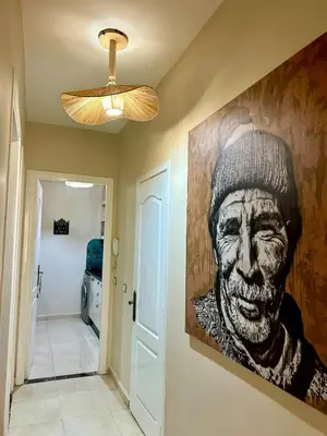 a painting of a man hanging on a wall at Dar Mimouna - Authenticité & Confort Moderne in Marrakech