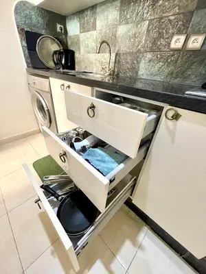 a kitchen with a sink and a washing machine at Dar Mimouna - Authenticité & Confort Moderne in Marrakech