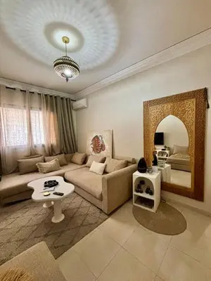 a living room with a couch and a table at Dar Mimouna - Authenticité & Confort Moderne in Marrakech