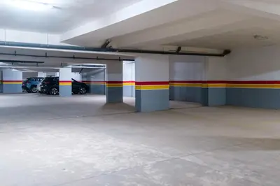 an empty parking garage with cars parked in it at 1BR Appart 2 min de M Avenue , Pool , Balcony & Parking & 24h j7 security in Marrakech