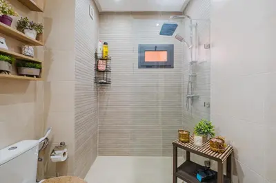 a bathroom with a shower with a glass door at 1BR Appart 2 min de M Avenue , Pool , Balcony & Parking & 24h j7 security in Marrakech