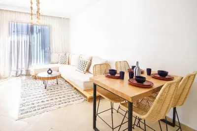 a living room with a couch and a table at La Menara - 2 Chambres - Centre - Wifi in Marrakech