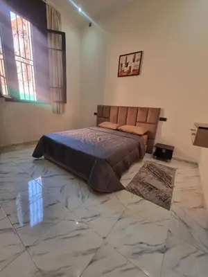 a bedroom with a bed and a marble floor at Guéliz Spirit in Marrakech