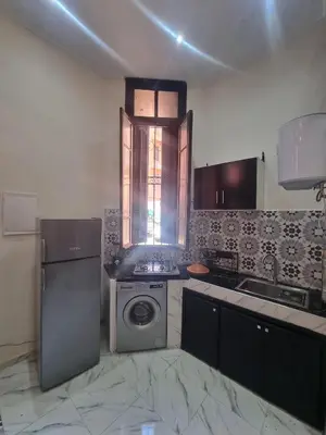 a kitchen with a washing machine and a sink at Guéliz Spirit in Marrakech