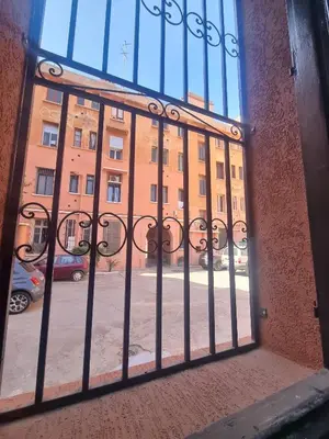 a view of a building through a barred window at Guéliz Spirit in Marrakech