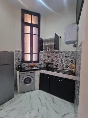 a kitchen with a sink and a washing machine at Guéliz Spirit in Marrakech