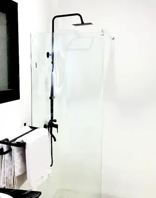 a glass shower in a bathroom with a mirror at Les Paniers de MARRAKECH 1 in Marrakech