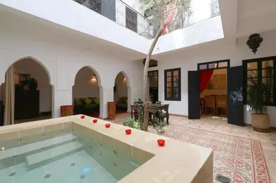 an indoor pool in a house with a large room at Riad XCIX, basin, 3 bedrooms in Medina excluded in Marrakech