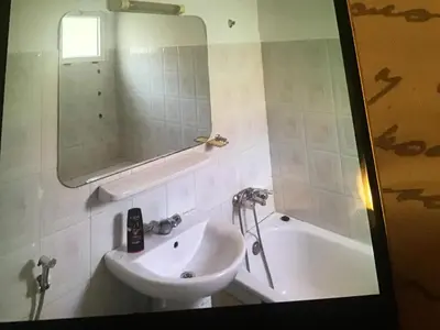 a bathroom with a sink and a tub and a mirror at Marrakech village touristique in Marrakech