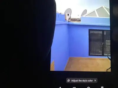 a room with a blue wall and a wooden floor at Marrakech village touristique in Marrakech