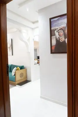 a room with a couch and a painting on the wall at Appartement de luxe, à 2min de Guéliz in Marrakech