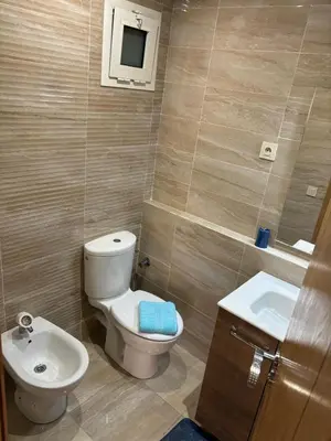 a bathroom with a toilet and a sink at Gemütliche Wohnung in Marakesch in Marrakech