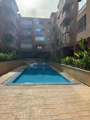 a swimming pool in the middle of a building at Gemütliche Wohnung in Marakesch in Marrakech