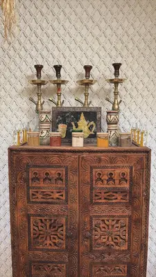 a wooden cabinet with vases on top of it at Riad Amskal in Marrakech