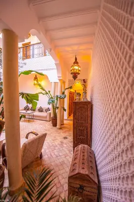a living room with a couch and a table at Riad Amskal in Marrakech