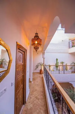a hallway of a house with a chandelier at Riad Amskal in Marrakech
