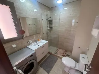 a bathroom with a toilet sink and a shower at Prestigia residences in Marrakech