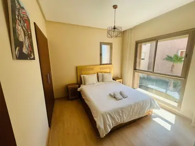 a bedroom with a bed with two towels on it at Prestigia residences in Marrakech