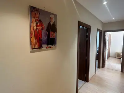 a painting hanging on a wall in a room at Prestigia residences in Marrakech