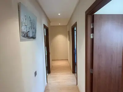 a hallway with a door and a painting on the wall at Prestigia residences in Marrakech