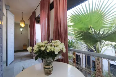 a vase of flowers on a table in a room at Riad La Tulipe, private, 4 Ch, medina in Marrakech