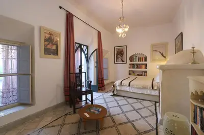 a living room with a bed and a window at Riad La Tulipe, private, 4 Ch, medina in Marrakech