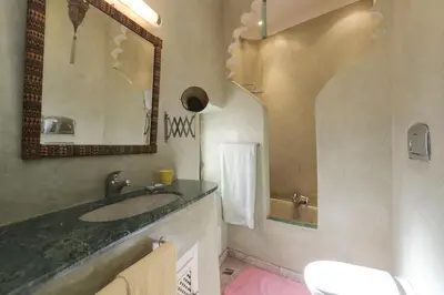 a bathroom with a sink and a mirror at Riad La Tulipe, private, 4 Ch, medina in Marrakech