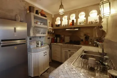 a kitchen with a sink and a refrigerator at Riad La Tulipe, private, 4 Ch, medina in Marrakech